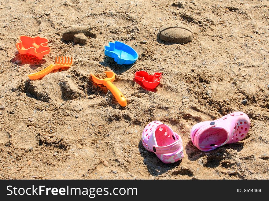 Plastic colorful beach toys on sand