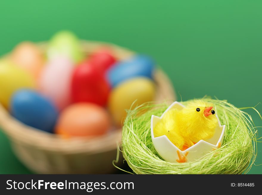 Chicken in nest and basket with multicolored eggs. Chicken in nest and basket with multicolored eggs