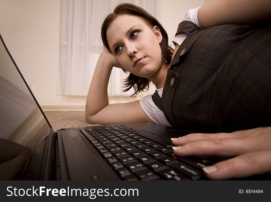 Woman with laptop on carpet