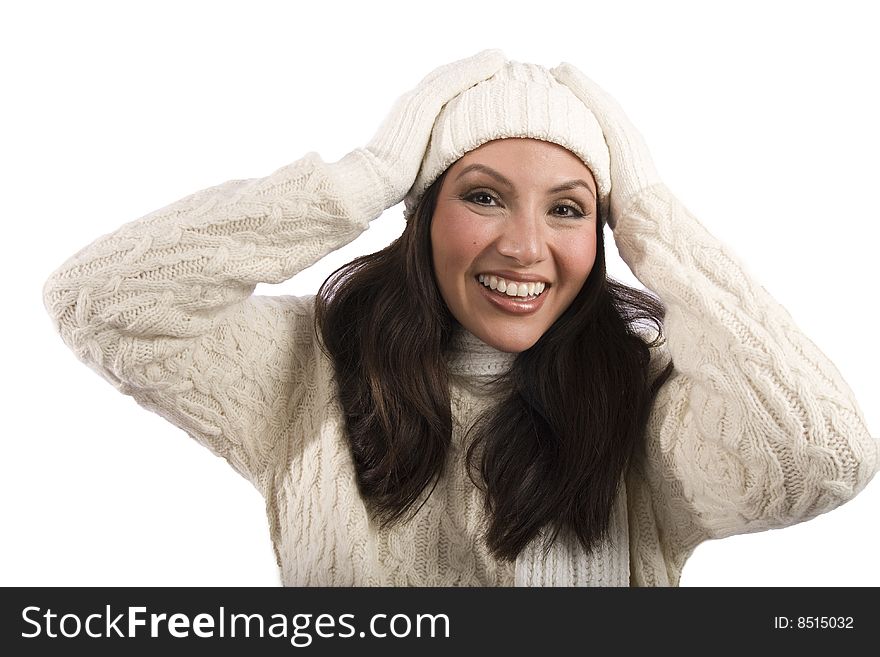 A pretty asian woman in winter clothing holds her hands to her head. A pretty asian woman in winter clothing holds her hands to her head