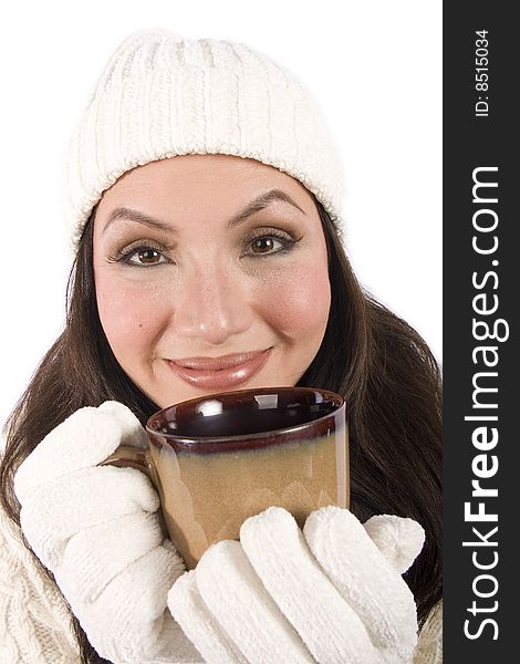 A pretty asian woman drinks a hot beverage in winter clothes. A pretty asian woman drinks a hot beverage in winter clothes