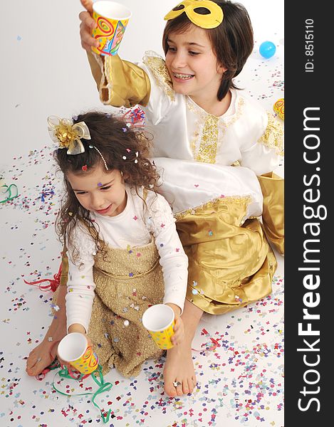 A child and a  little girl  are playing throwing confetti. A child and a  little girl  are playing throwing confetti