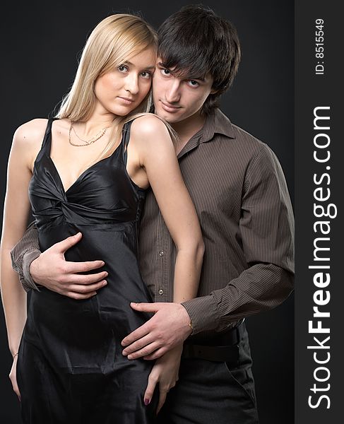 Young couple man and woman on black background