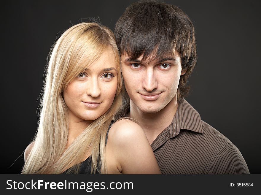 Young couple man and woman on black background