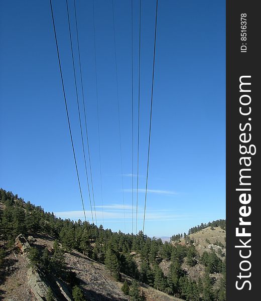 Power lines fade into the hillside. Power lines fade into the hillside