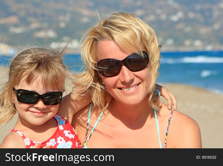 Happy mum with a daughter have a rest on the sea