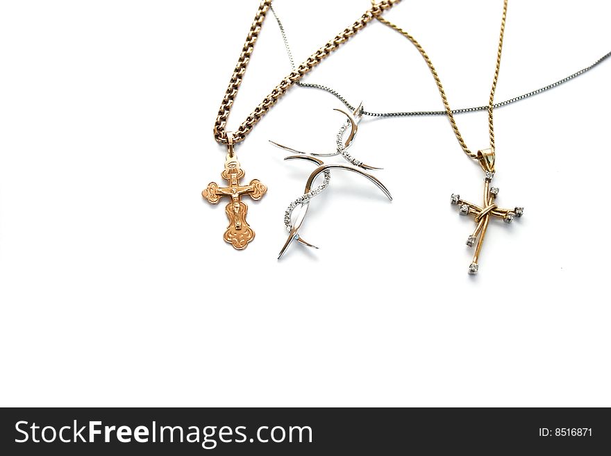 Gold and silver crosses on white background.