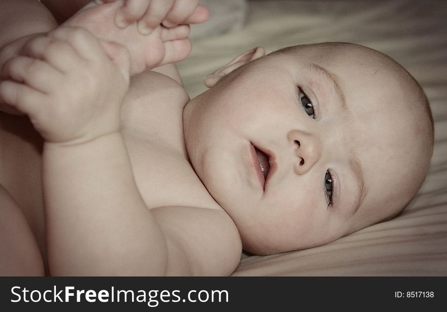 A young Caucasian baby with toes. A young Caucasian baby with toes