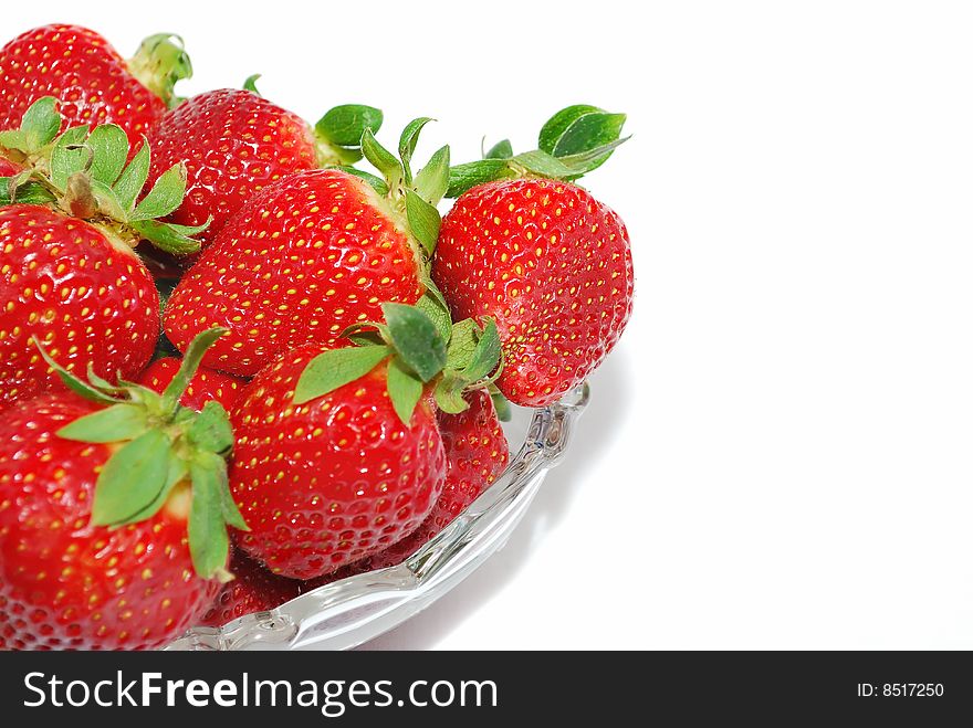 Isolated object - Strawberries in the glass bowl lose on white background. Isolated object - Strawberries in the glass bowl lose on white background.