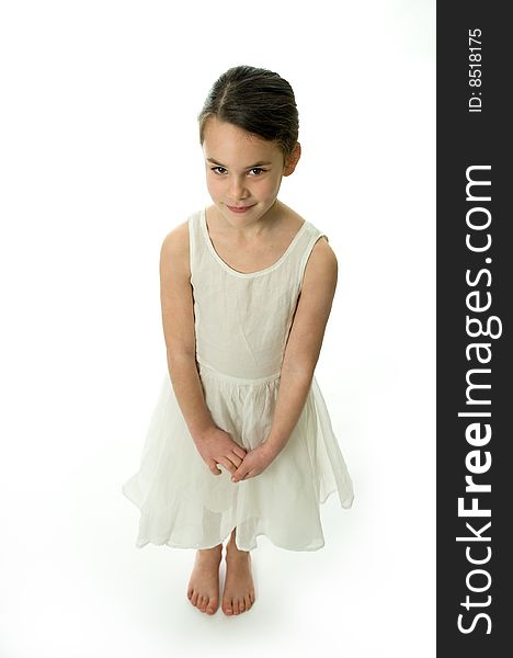 Little girl smiling confident in camera, isolated on white background. Showing an elegant white dress. Little girl smiling confident in camera, isolated on white background. Showing an elegant white dress.