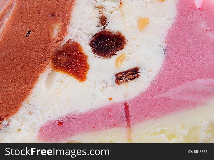 Colorful Ice-cream closeup with raisins and chocolate bits inside. Colorful Ice-cream closeup with raisins and chocolate bits inside