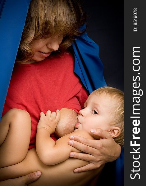 Mom and baby on black in studio