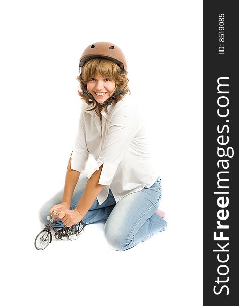 Portrait of a girl in a helmet with a toy bicycle