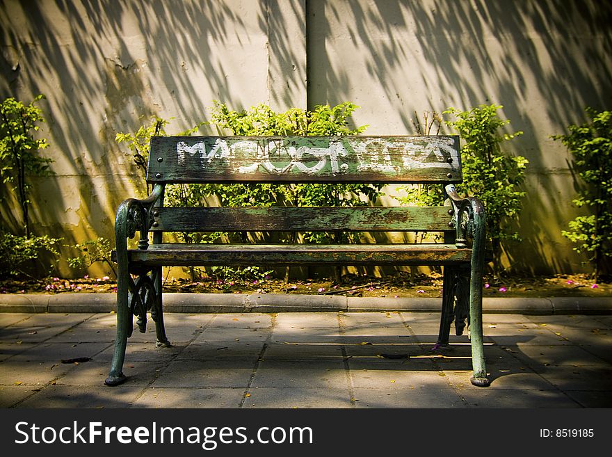 Empty public bench in afternoon sun