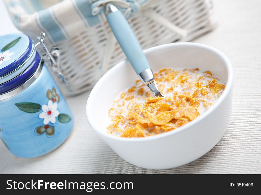 Milk and cornflakes on the white background