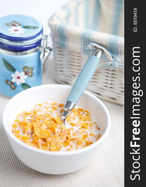 Milk and cornflakes on the white background