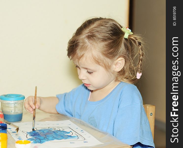 Toddler girl draws by paint. Toddler girl draws by paint