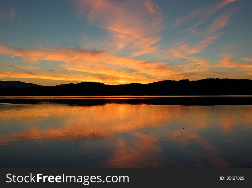 Lake Near The Mountains Under The Blue Sky