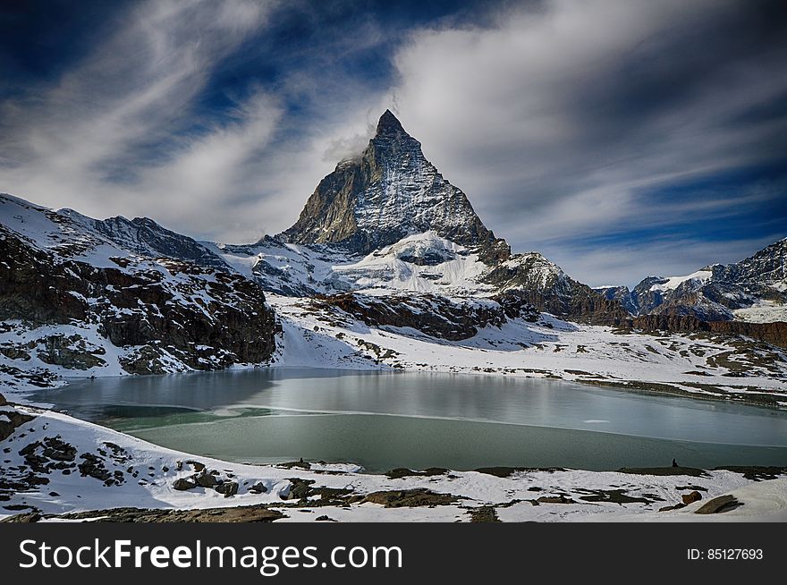 Alpine lake with snow covered peaks of Alps in Zermatt, Switzerland. Alpine lake with snow covered peaks of Alps in Zermatt, Switzerland.