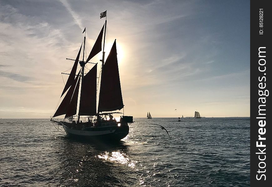 Sailboat In Open Sea At Sunset