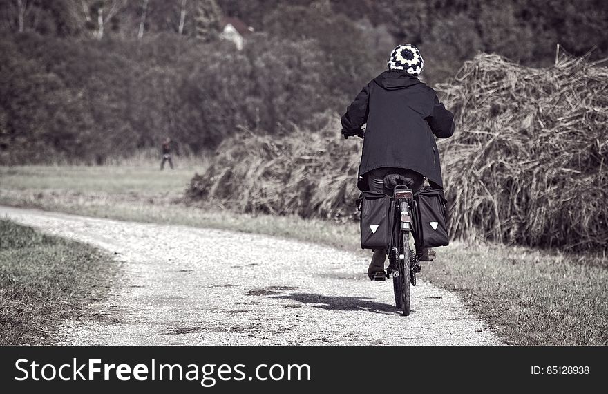 A bicyclist on a gravel road. A bicyclist on a gravel road.