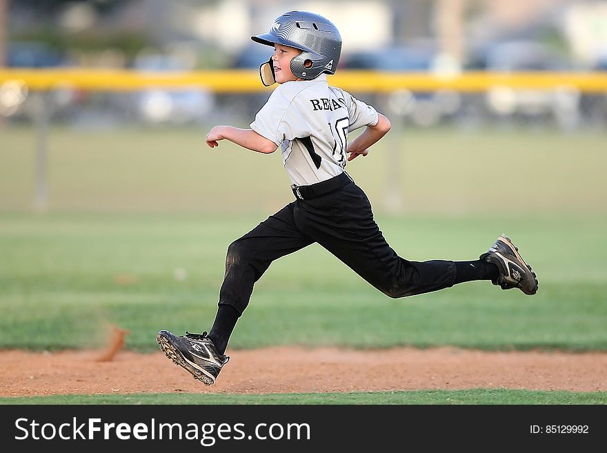 Baseball Player in Gray and Black Uniform Running