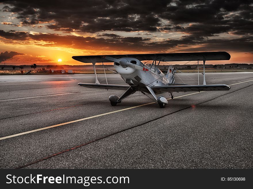 Black and White Aviation Plane Arriving during Sunset