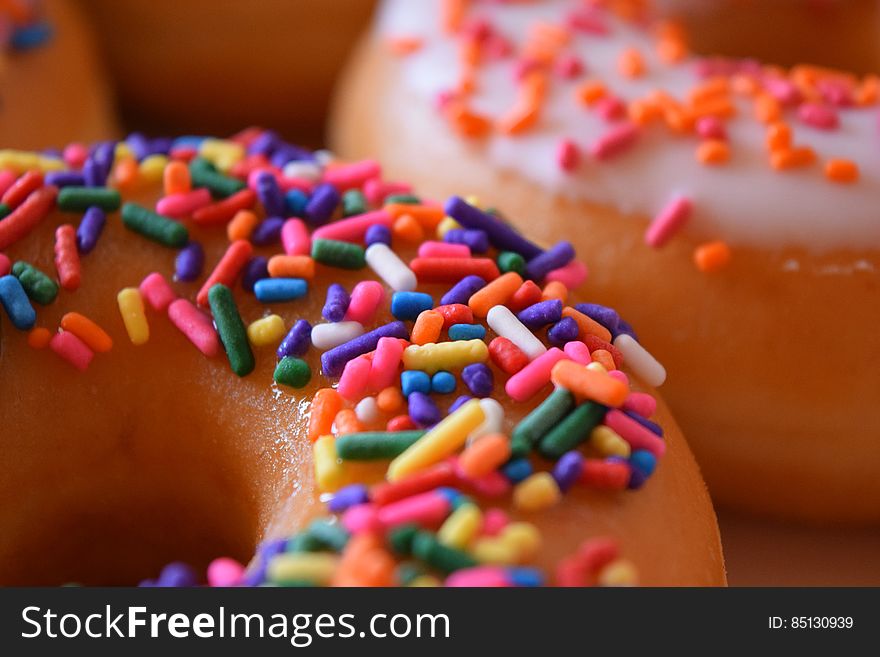 Close up of donuts with colorful sprinkles on them. Close up of donuts with colorful sprinkles on them.