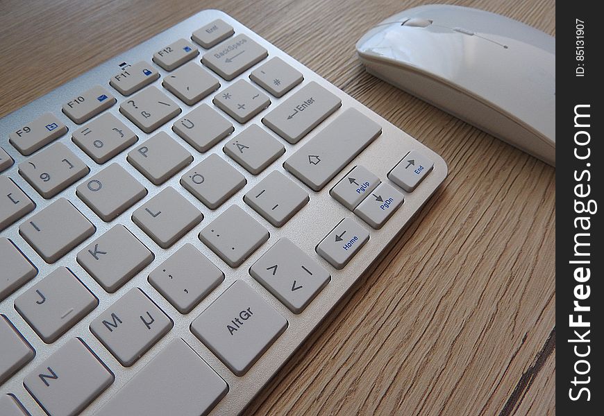 A close up of computer keyboard and mouse.