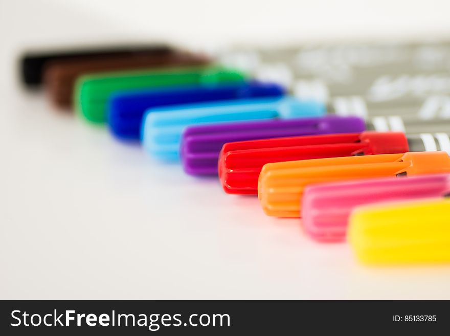 A close up of colorful markers in a row.