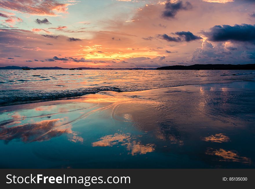 View from the beach at sunset at the sea. View from the beach at sunset at the sea.