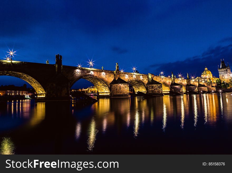 Brown And Black Concrete Bridge During Night