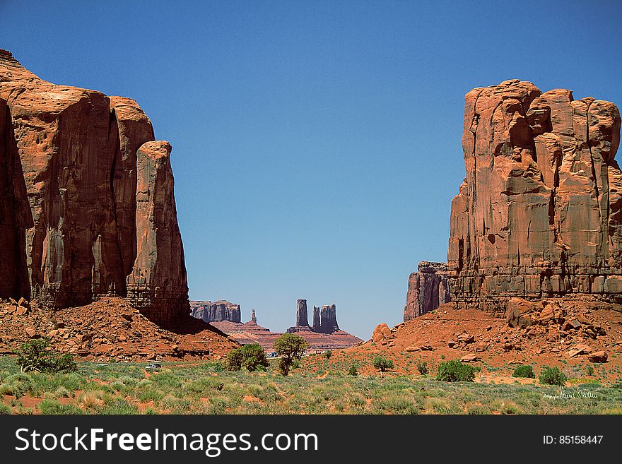 Sandstone rock formations in desert landscape on sunny day with blue skies.