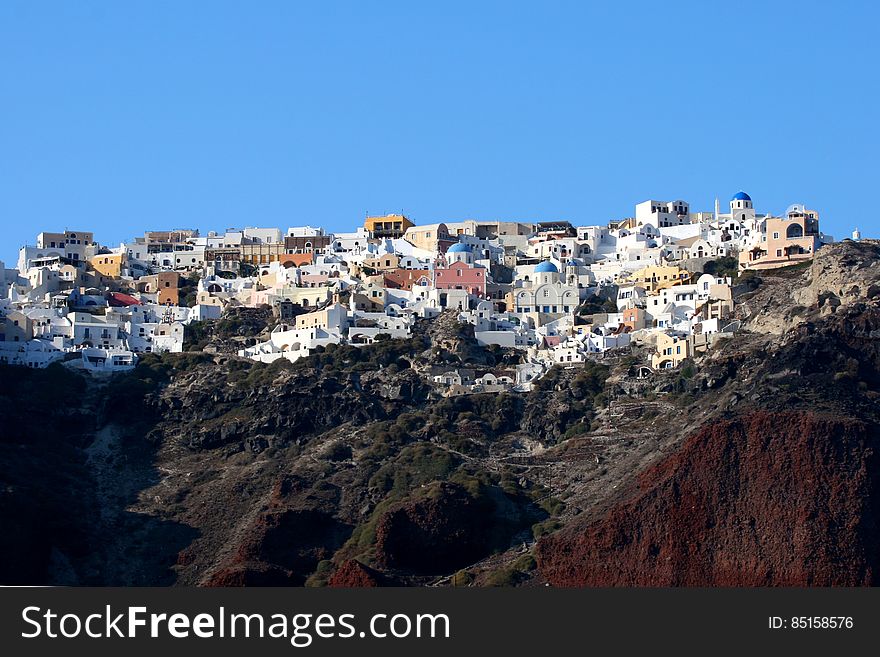 City on the mountainous coastline of Santorini island in Greece. City on the mountainous coastline of Santorini island in Greece.