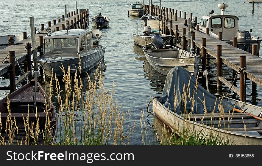 Cluster Of Grey Motorboat On Brown Wooden Dock