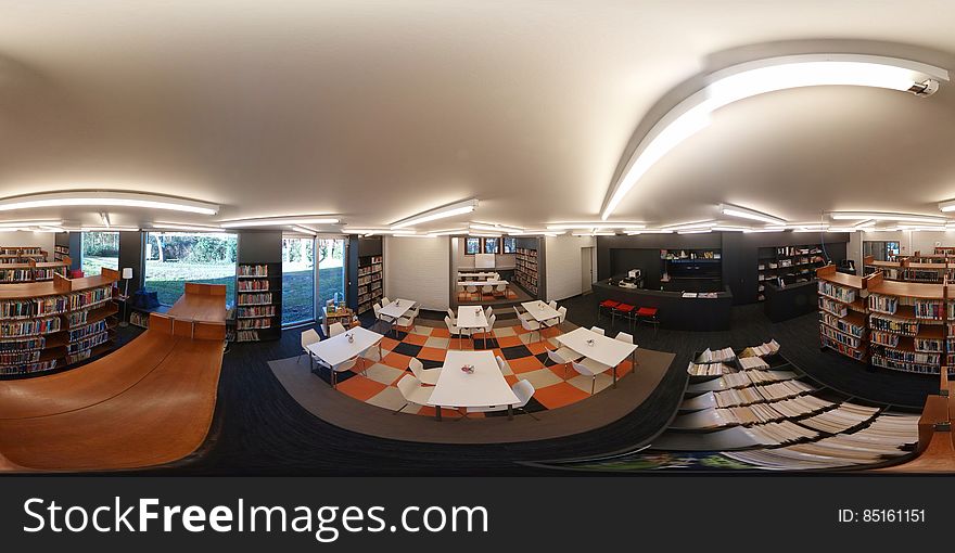 Inside modern library or bookstore reading room with shelves. Inside modern library or bookstore reading room with shelves.