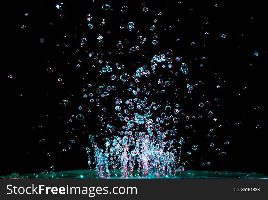 A close up of abstract water bubbles on a black background.