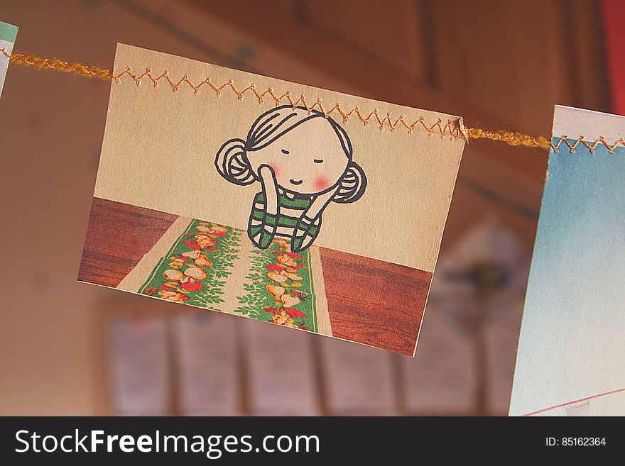 A drawing of a girl leaning on his hands hanging from a line. A drawing of a girl leaning on his hands hanging from a line.