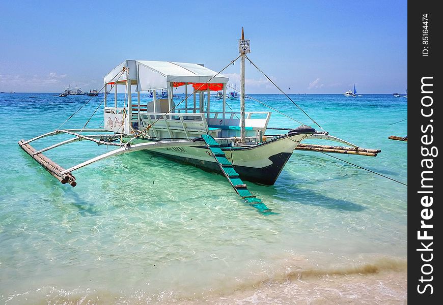 A traditional Asian trimaran boat on the shore. A traditional Asian trimaran boat on the shore.