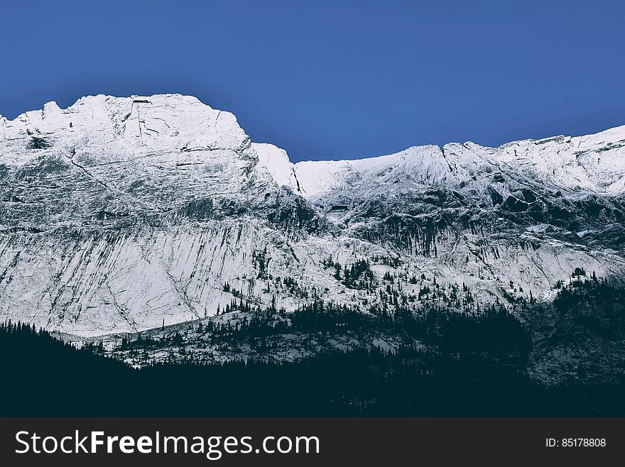 A view of a snowy mountain range. A view of a snowy mountain range.