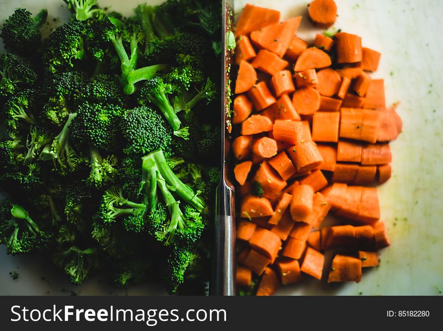 A portion of fresh broccoli and chopped carrots. A portion of fresh broccoli and chopped carrots.