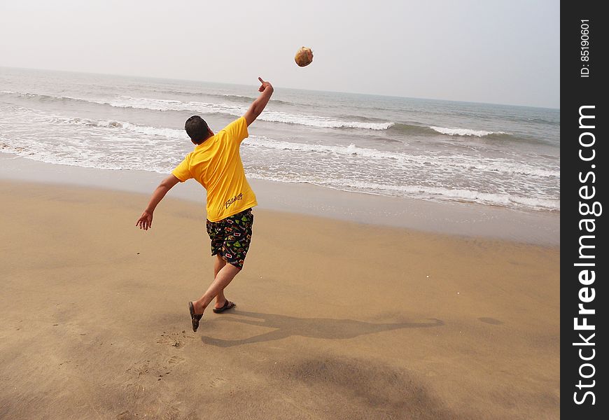 Guy Throwing Coconut In Sea