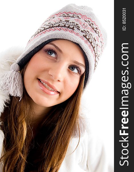 Blonde female with cap and looking upward on an isolated white background