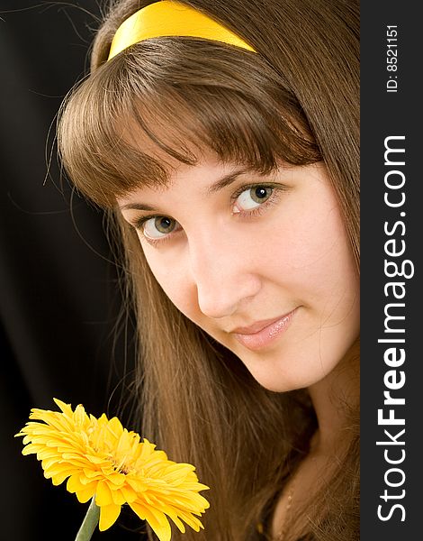 Portrait of beautiful girl with yellow flower