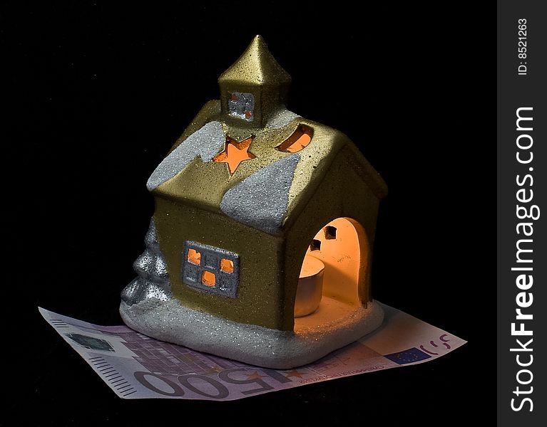 The small house on euro and shined from within, in a night-time, at night