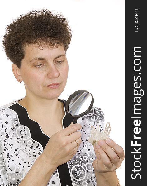 Curly woman with magnifying glass and stone on white background