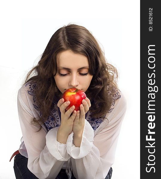 Young beautiful girl enjoys the aroma of apple. Young beautiful girl enjoys the aroma of apple