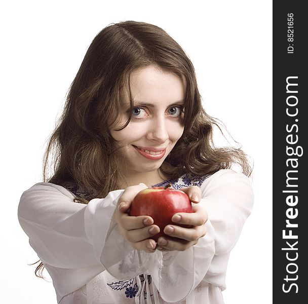 Young beautiful girl stretches out you a red apple. Young beautiful girl stretches out you a red apple