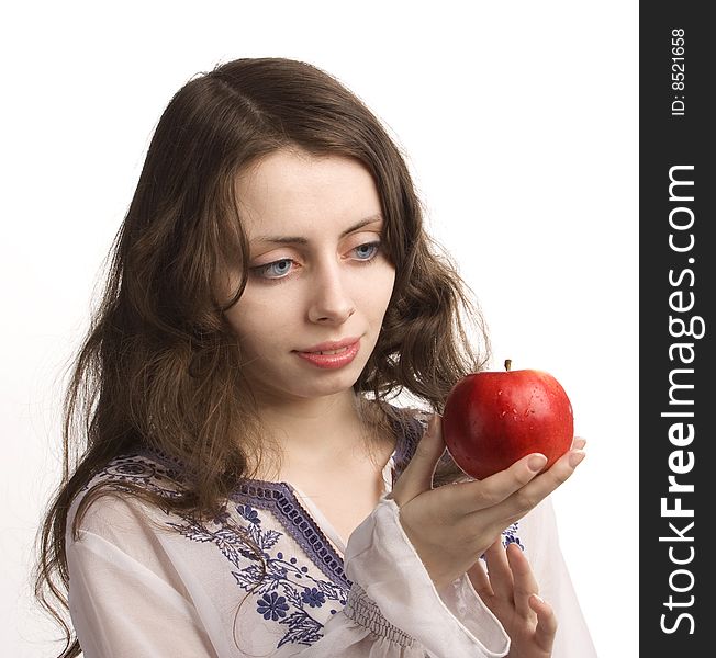 Young beautiful girl stretches out you a red apple. Young beautiful girl stretches out you a red apple