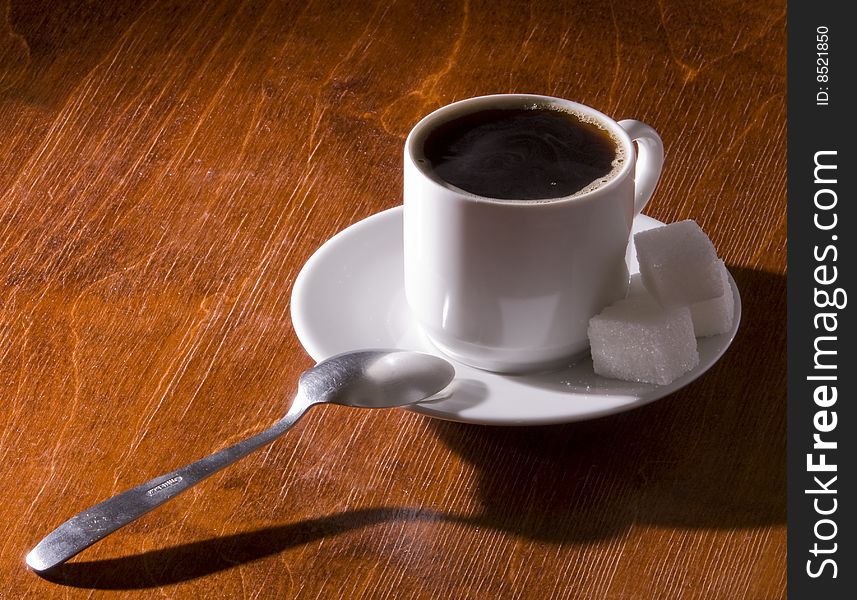 Cup of hot black coffee with sugar